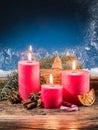Cristmas candle lights and frozen window. Royalty Free Stock Photo