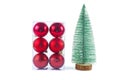 Cristmas decoration:set of red balls and artificial tiny cristmas tree isolated on a white