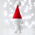 Cristmas toy in Red Hat Santa Claus, Symbol New Year, Defocused Lights White Background Royalty Free Stock Photo