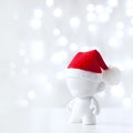 Cristmas toy in Red Hat Santa Claus, Symbol New Year, Defocused Lights White Background Royalty Free Stock Photo