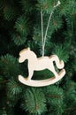 Cristmass NChristmas wooden toy horse on the green Christmas tree Royalty Free Stock Photo