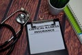 Critical Illness Insurance write on paperwork isolated on wooden table Royalty Free Stock Photo