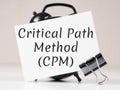 Critical Path Method (CPM) text meaning on white note paper background alarm clock Royalty Free Stock Photo