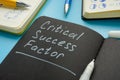 Critical success factor memo in the notepad and pen. Royalty Free Stock Photo