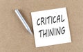 CRITICAL THINING text on a sticky note on cork board with pencil Royalty Free Stock Photo