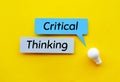 Critical thinking Idea and creativity concepts with lightbulb and speech bubbles paper on yellow Royalty Free Stock Photo
