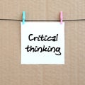 Critical thinking. Note is written on a white sticker that hangs Royalty Free Stock Photo