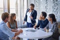 Critiquing the team. a group of colleagues working together in an office. Royalty Free Stock Photo