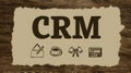 CRM Concept with Illustrations of Communication, Coffee, and Document Management on Rustic Background Royalty Free Stock Photo