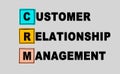 CRM customer relation management abbreviation on gray background, loyalty program, repeat purchase frequency concept Royalty Free Stock Photo