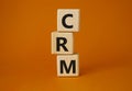 CRM - Customer relationship management symbol. Concept word CRM on wooden cubes. Beautiful orange background. Business and CRM Royalty Free Stock Photo