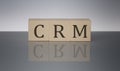 CRM Customer Relationship Marketing concept, wooden word block on the grey background