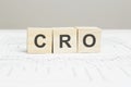 CRO wooden blocks word on grey background. CRO - conversion rate optimization, information concepts