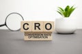 CRO wooden blocks word on grey background. CRO - short for Conversion Rate Optimization, information concepts