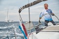 Croatia, Adriatic Sea, 19 September 2019: The brutal captain of the boat is at a steering wheel, jacket of blue color