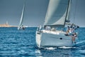 Croatia, Adriatic Sea, 17 September 2019: The race of sailboats, the team sits on the edge of a boat board, a regatta