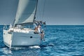 Croatia, Adriatic Sea, 17 September 2019: The race of sailboats, the team sits on the edge of a boat board, a regatta