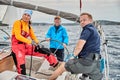 Croatia, Adriatic Sea, 19 September 2019: The race of sailboats, the team sits on the edge of a boat board, team work