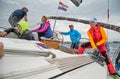 Croatia, Adriatic Sea, 19 September 2019: The race of sailboats, the team sits on the edge of a boat board, team work