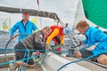 Croatia, Adriatic Sea, 19 September 2019: The race of sailboats, the team sits on the edge of a boat board, team work