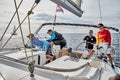 Croatia, Adriatic Sea, 19 September 2019: The race of sailboats, the team sits on the edge of a boat board, team work