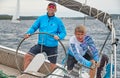 Croatia, Adriatic Sea, 19 September 2019: The race of sailboats, the team sits on the edge of a boat board, team work