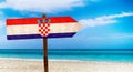 Croatia flag on wooden table sign on beach background. It is summer sign of Croatia