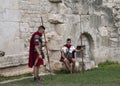 Re-enactors dressed as Roman Legionnaires, wait to pose with Tourists at the gates to the Diocletian Palace Royalty Free Stock Photo