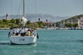 Croatia, Trogir, 20 September 2019: Seaview of sail boat with sailors, cityscape from level of water, tower, cityscape