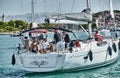 Croatia, Trogir, 20 September 2019: Seaview of sail boat with sailors, cityscape from level of water, tower, cityscape