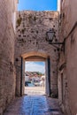 Croatia.View through the gates of the old town of Trogir to the new part, the gulf of the Adriatic sea with boats. Royalty Free Stock Photo