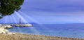 Croatian beach and Adriatic Sea with visible sun rays - Tucepi, Makarska Riviera, Croatia Royalty Free Stock Photo
