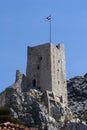 Croatian flag on fortress Mirabella Peovica above the town Omis in Croatia Royalty Free Stock Photo