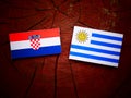 Croatian flag with Uruguaian flag on a tree stump Royalty Free Stock Photo