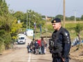 Croatian policeman looking at micrants crossing the Serbia Croatia border in Berkasovo Bapska, on the Balkans Route
