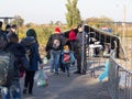 Croatian policeman looking at refugees, mainly children, crossing the Serbia Croatia border in Berkasovo Bapska