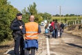 Croatian policeman and NGO Volunteer looking at migrants crossing the Serbia Croatia border in Berkasovo Bapska