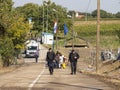 Croatian policemen walking in front of a group of Refugees on the Croatian border crossing on the Croatia Serbia border