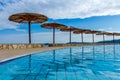 Croatian Swimming pool with tropical sunshades Royalty Free Stock Photo