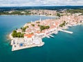 Croatian town of Porec, shore of blue azure turquoise Adriatic Sea, Istrian peninsula, Croatia. Bell tower, red tiled roofs.