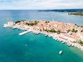 Croatian town of Porec, shore of blue azure turquoise Adriatic Sea, Istrian peninsula, Croatia. Bell tower, red tiled roofs.