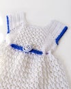 Crochet baby product. Set of clothes and accessories on white background.