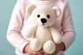 Crochet Beige bear in girl hands. Cute handmade toy. Japanese amigurumi