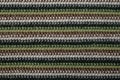 crochet fabric texture with brown, gray, green and black colored lines, abstract close up pattern Royalty Free Stock Photo