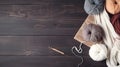 Crochet and knitting hobby. Colorful balls of yarn, knitting needles on table, with copy space, flat lay, and wood background