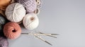 Crochet and knitting hobby. Colorful balls of yarn, knitting needles on table, with copy space, flat lay, and wood background