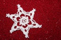 Crochet Lace Snowflake with Red Beaded Background Royalty Free Stock Photo