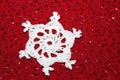Crochet Snowflake with Red Bead Background Royalty Free Stock Photo