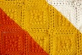 Crochet squares pattern, in red, yellow and white color Royalty Free Stock Photo