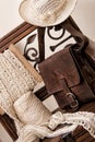 Crochet tools accompanied by elegant leather bag on chair in wood